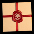 Corona Charms bracelet gift packaging with red ribbon and wax seal